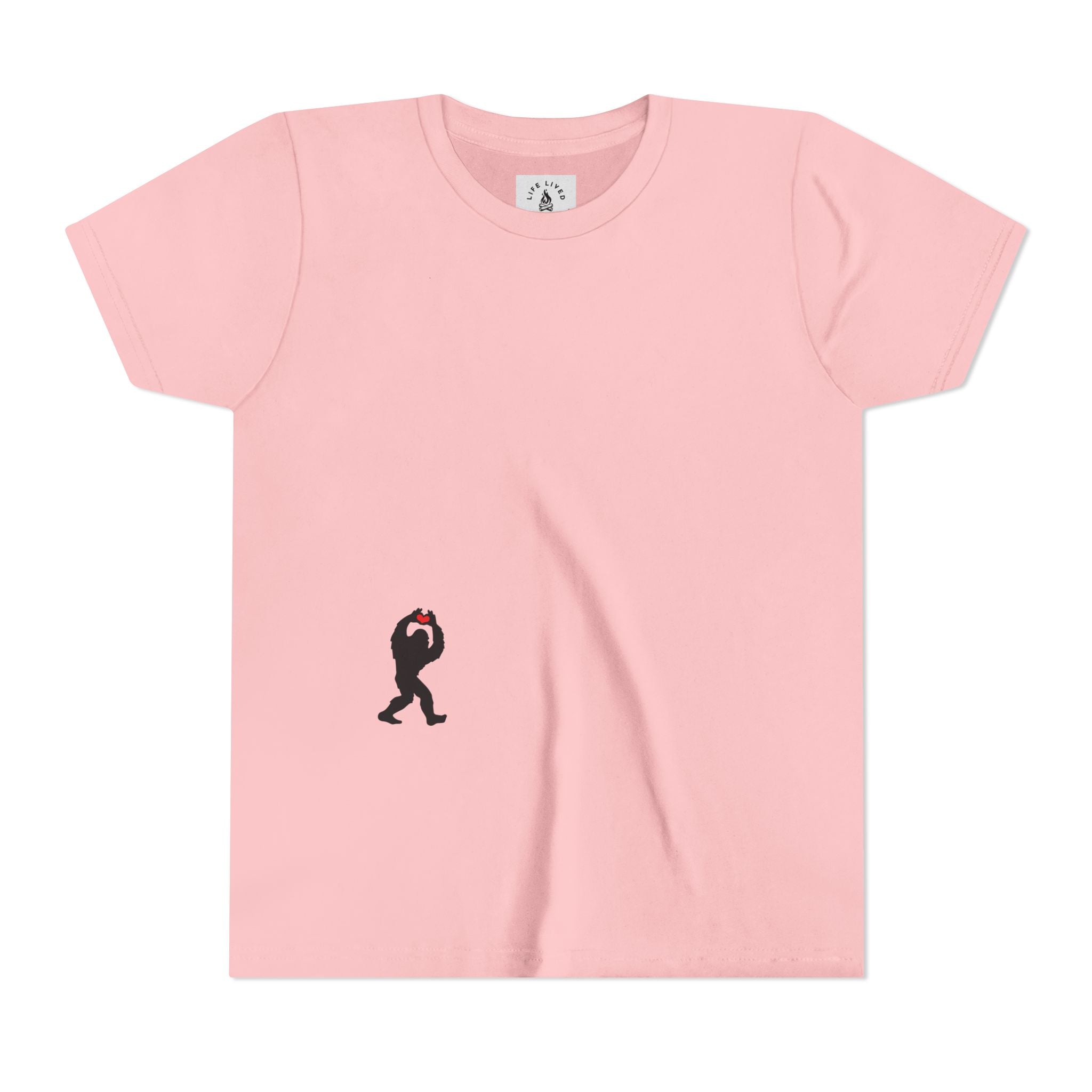 Pink t-shirt with small black Sasquatch graphic on lower front on a white background