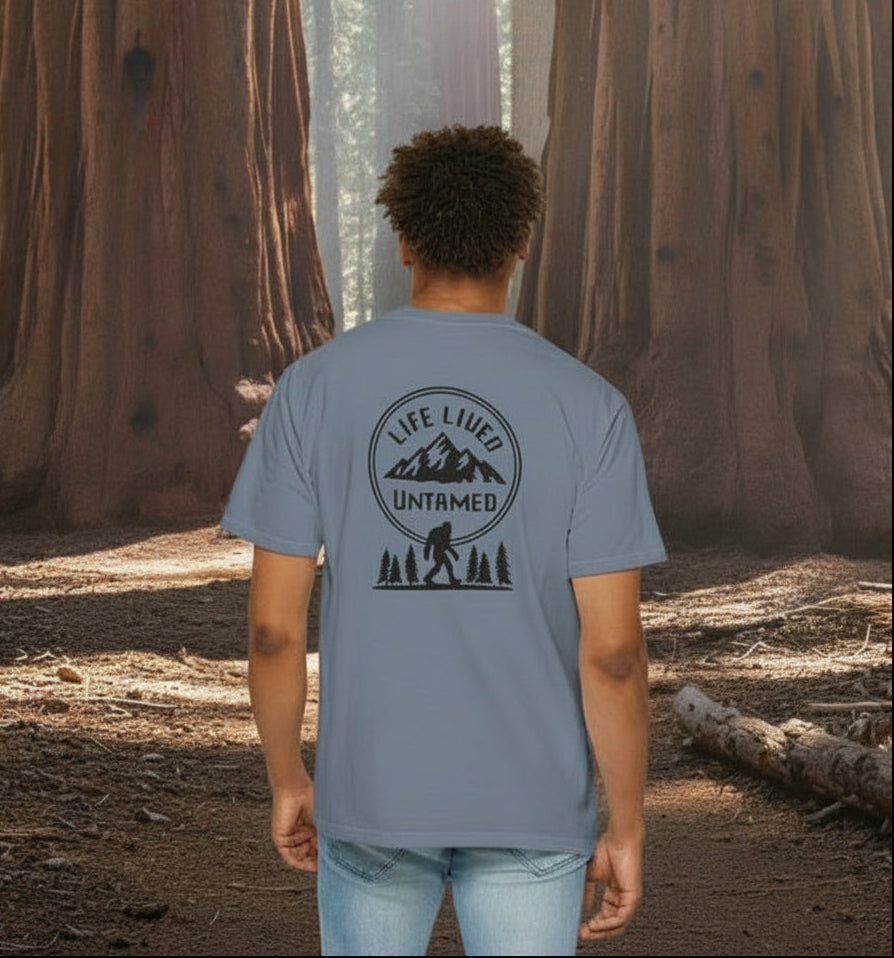 A blue jean with a graphic design on the back featuring mountains, trees, and a silhouette of a Sasquatch against Sequoia National Park background.