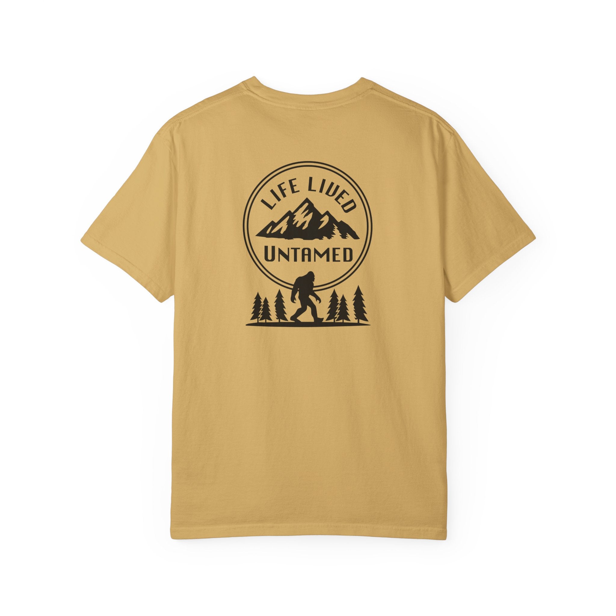 Mustard t-shirt with a graphic design on the back featuring mountains, trees, and a silhouette of a Sasquatch