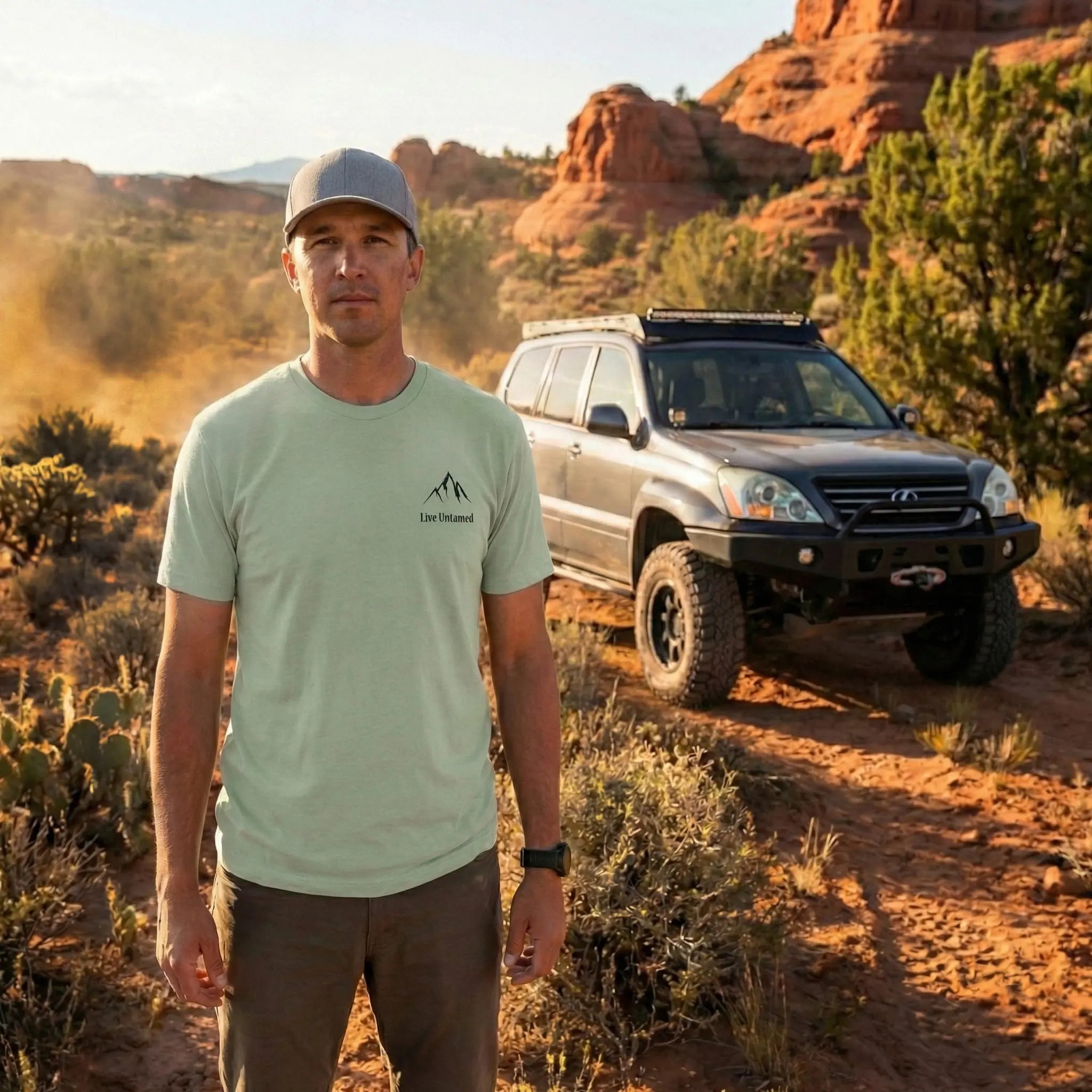 a man standing in front of his Lexus gx470 in the desert mountain