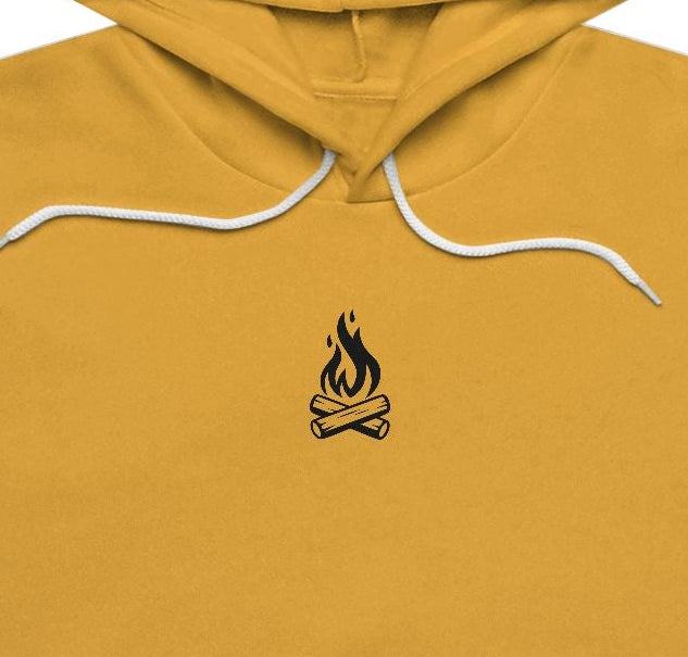 Yellow hoodie with a small campfire on the chest against a white background