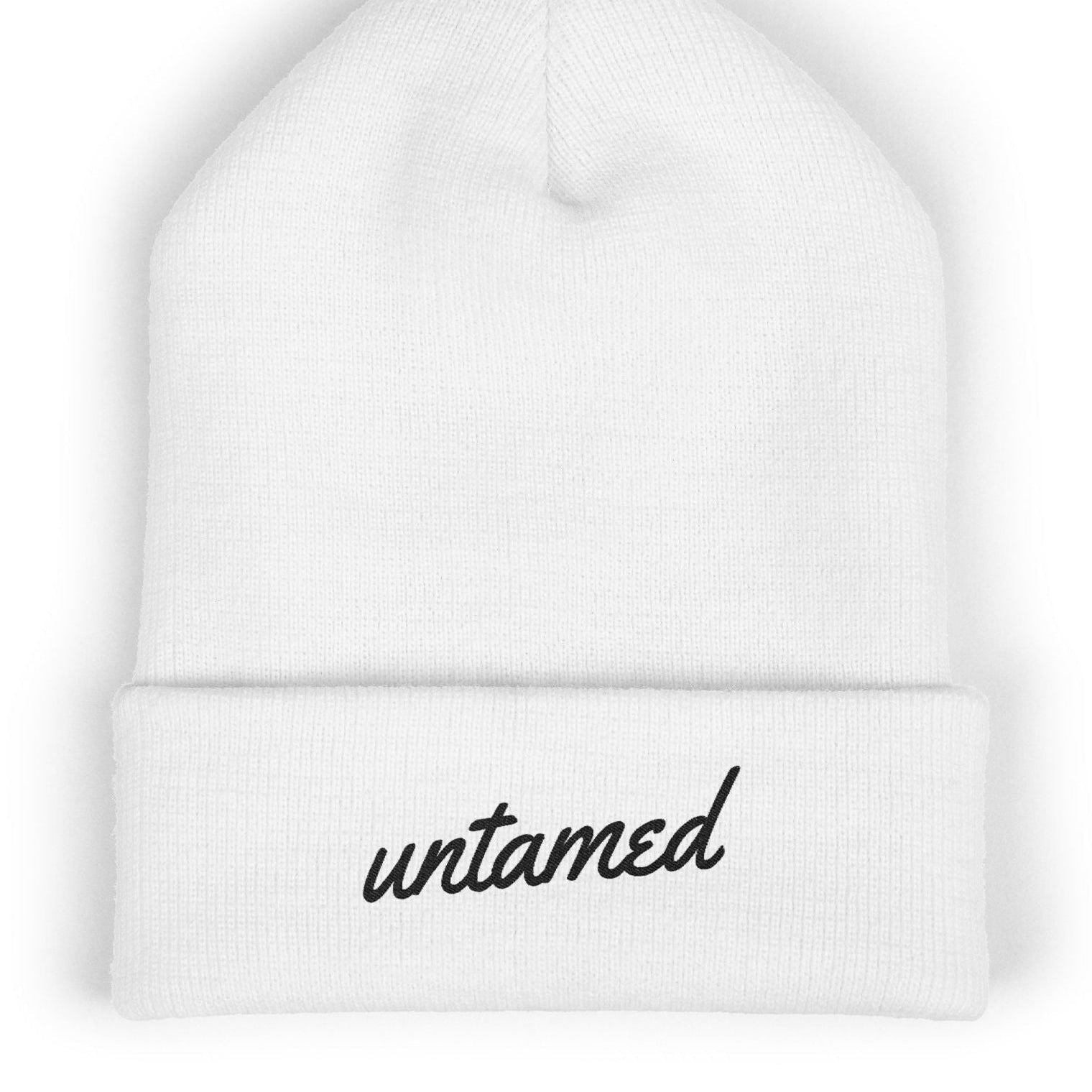 White beanie with 'untamed' text on a white background