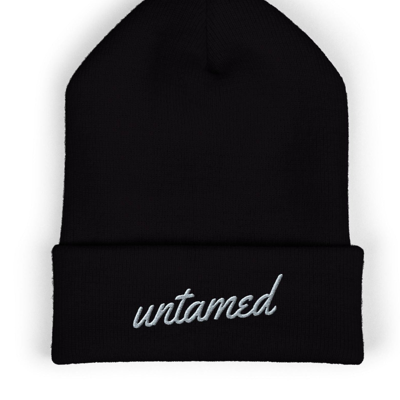 Black beanie with 'untamed' embroidery on a white background