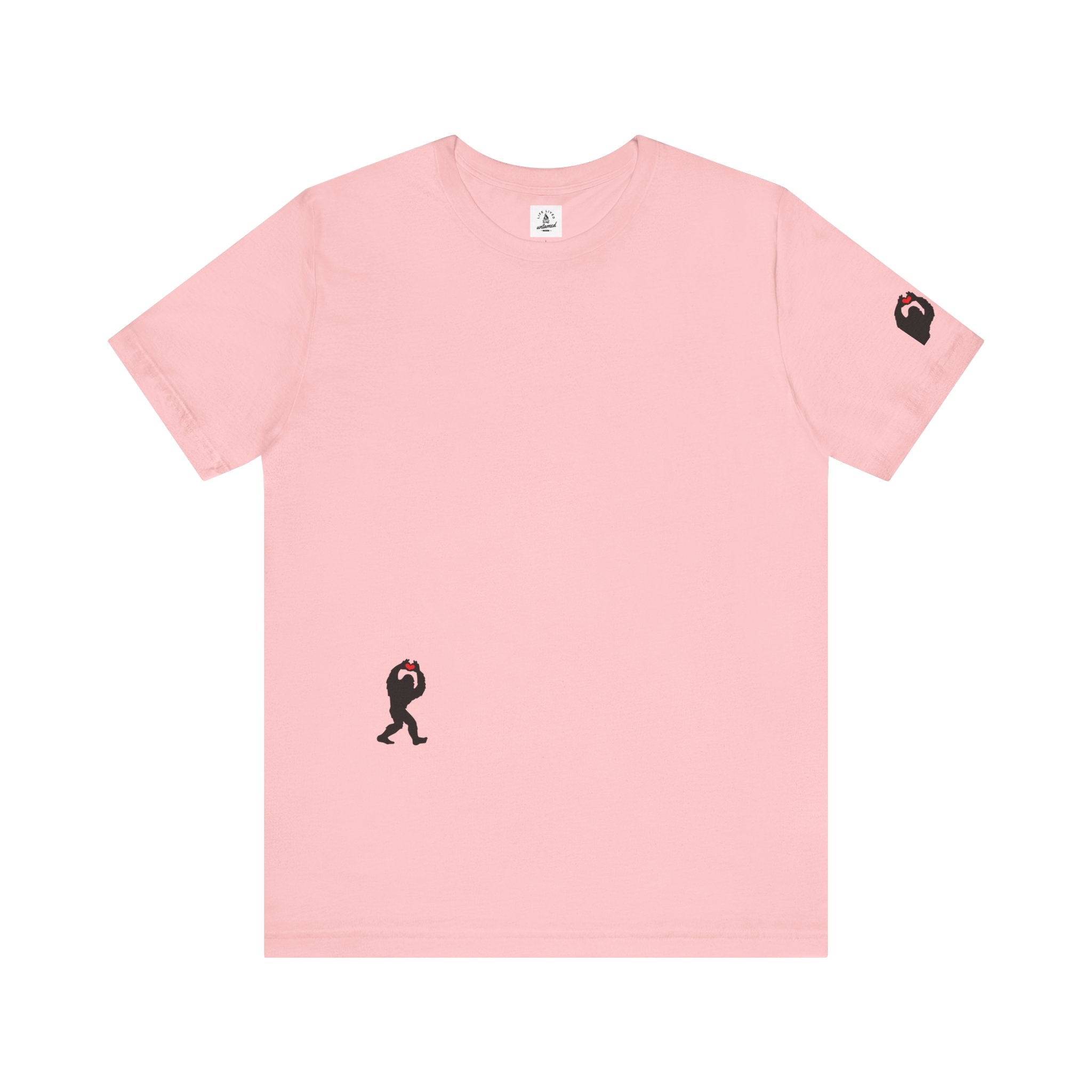 Women's pink t-shirt with small black Sasquatch graphic on lower front and a sleeve on a white background