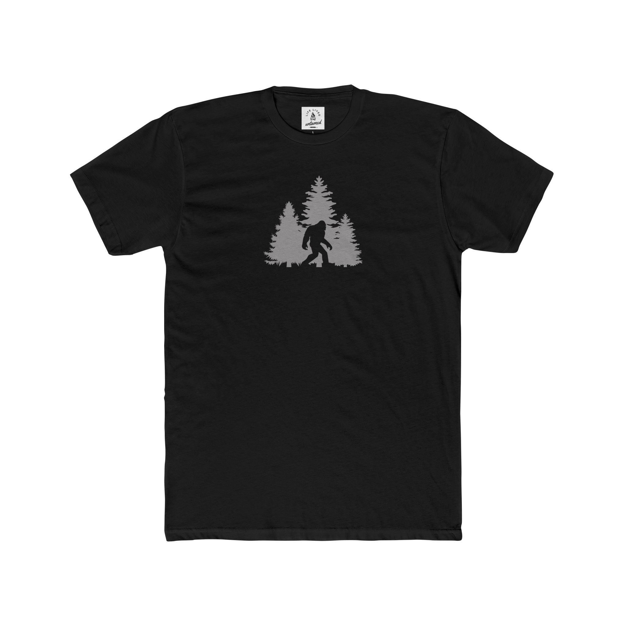 Black t-shirt with a white graphic of a forest and a bigfoot on a white background