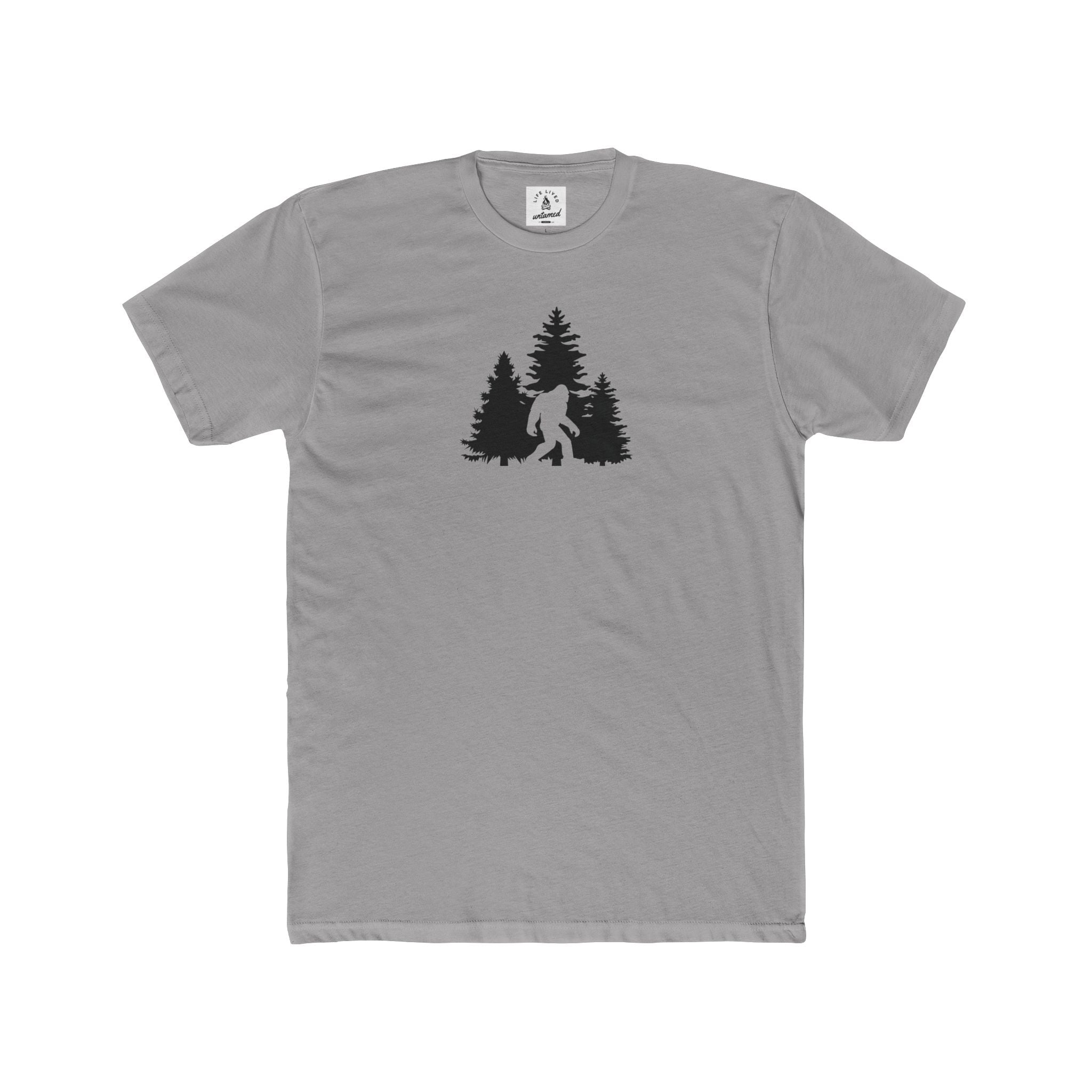 Gray t-shirt with a black graphic of a bigfoot and trees on a white background