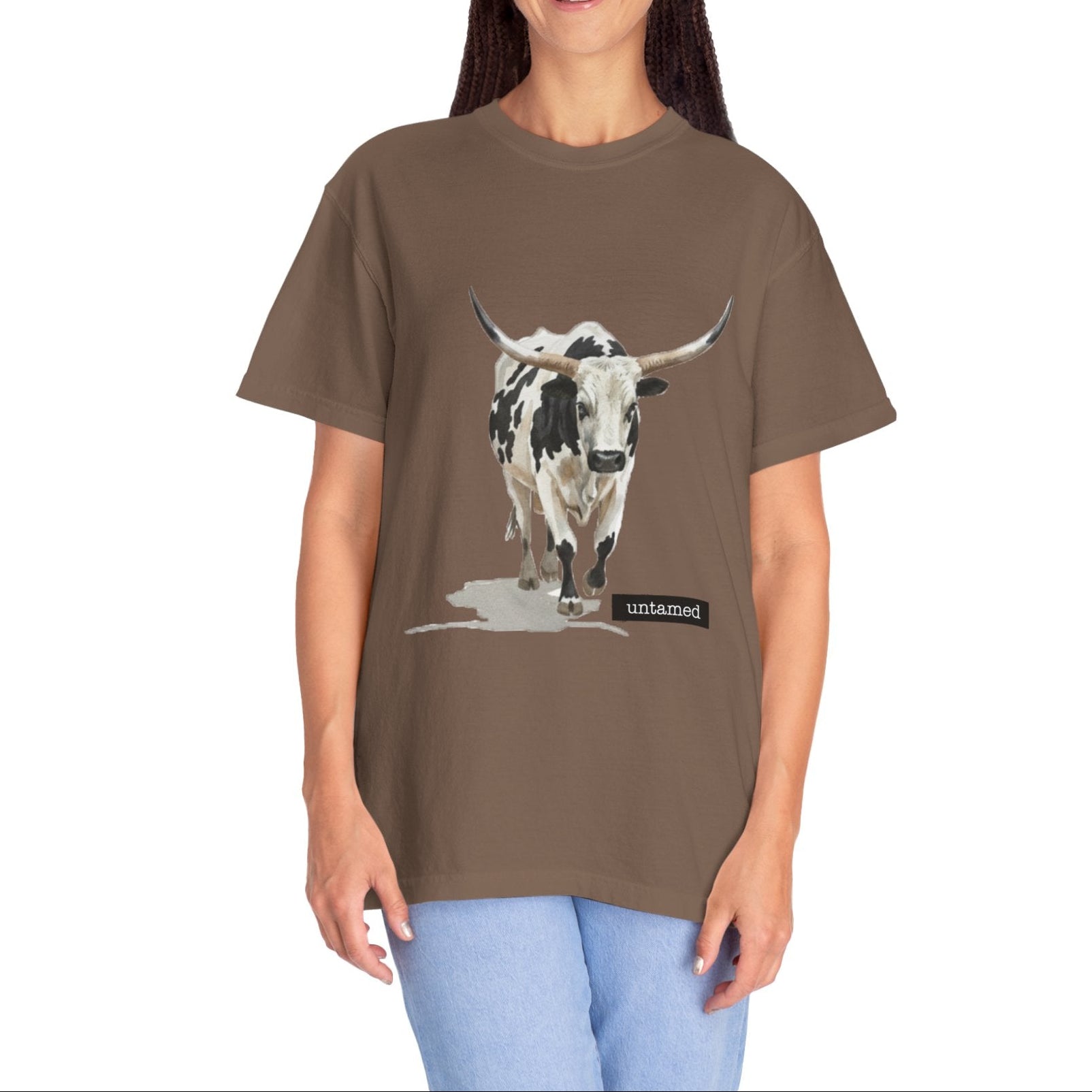 Woman wearing a brown t-shirt with a cow graphic on a white background