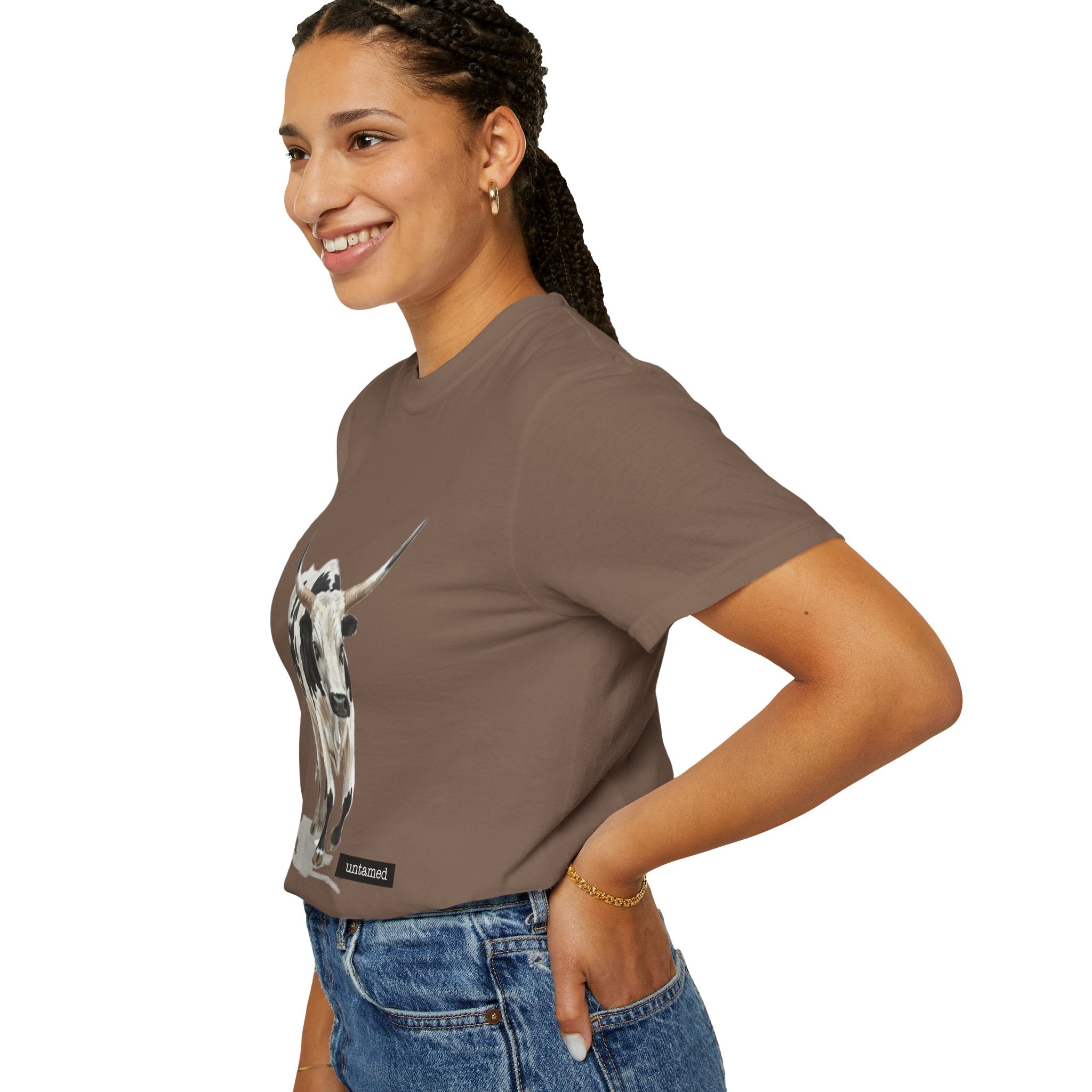 Woman wearing a brown t-shirt with a graphic design on a white background