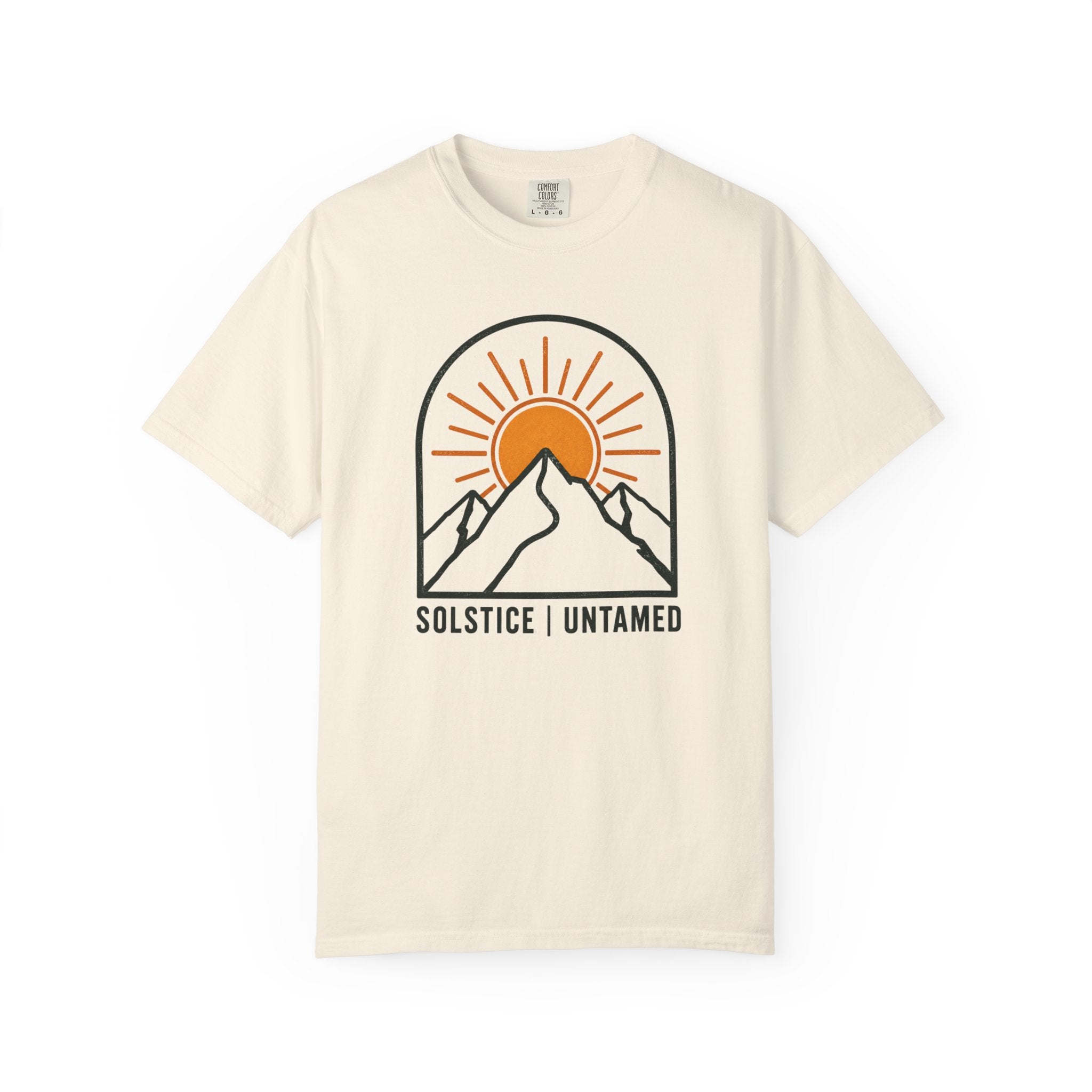 Ivory t-shirt with mountain and sun graphic and 'Solstice Untamed' text on a white background