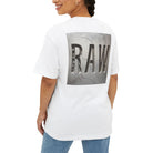 Woman wearing a white t-shirt with 'RAW' printed on the back, standing against a white background