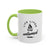 White mug with green handle and interior, featuring a campfire graphic and text on a white background.
