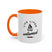 White mug with orange handle and interior, featuring a black graphic and text on a white background.