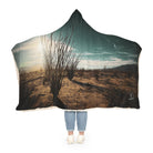 Person wearing a desert landscape-themed hooded blanket