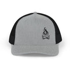 A light gray and black trucker hat displayed on a white background. The hat has a mesh back and a solid front with a small, black embroidered campfire with logs and flames.