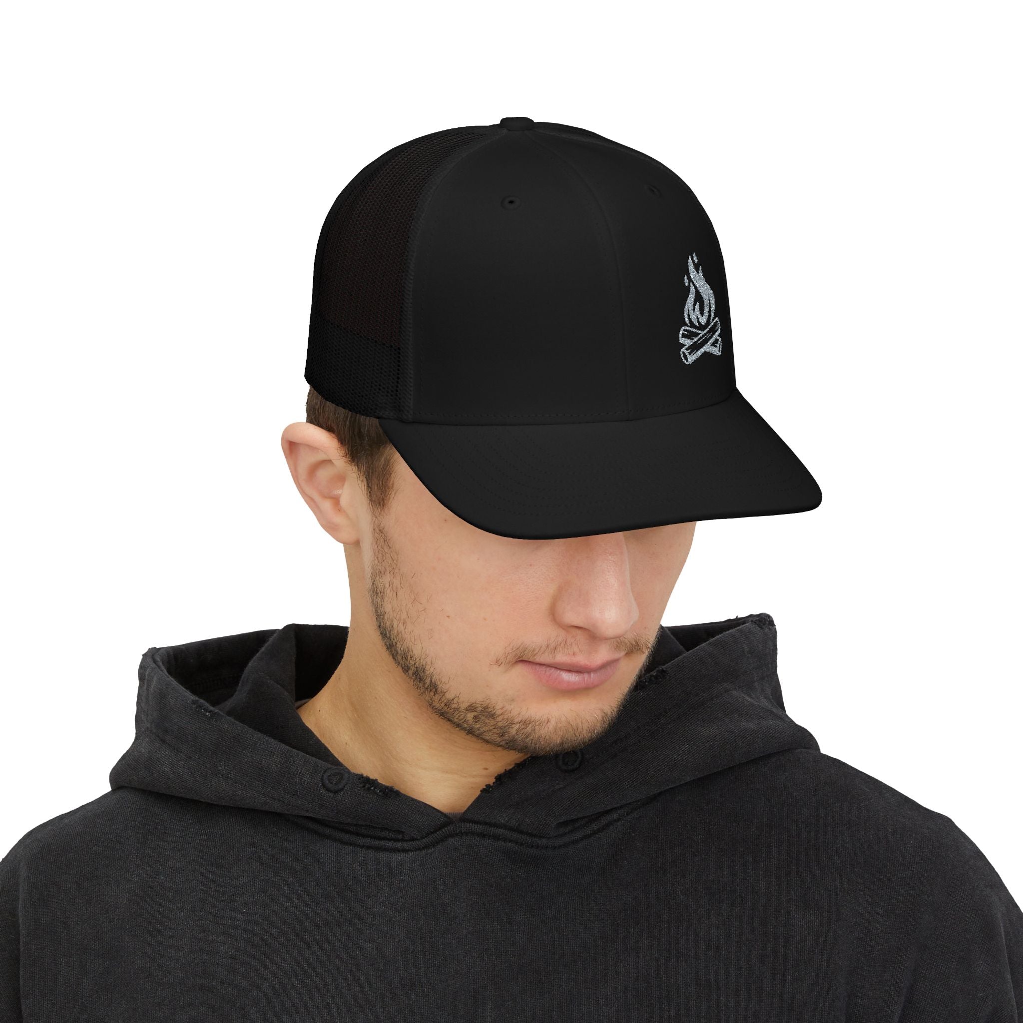 Man wearing a black campfire logo on a cap against a white background