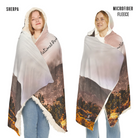 Two people wearing a landscape-themed blanket with 'National Park' text, one labeled 'Sherpa' and the other 'Microfiber Fleece'.