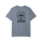 Blue jean t-shirt with a graphic design on the back featuring mountains, trees, and a silhouette of a Sasquatch.