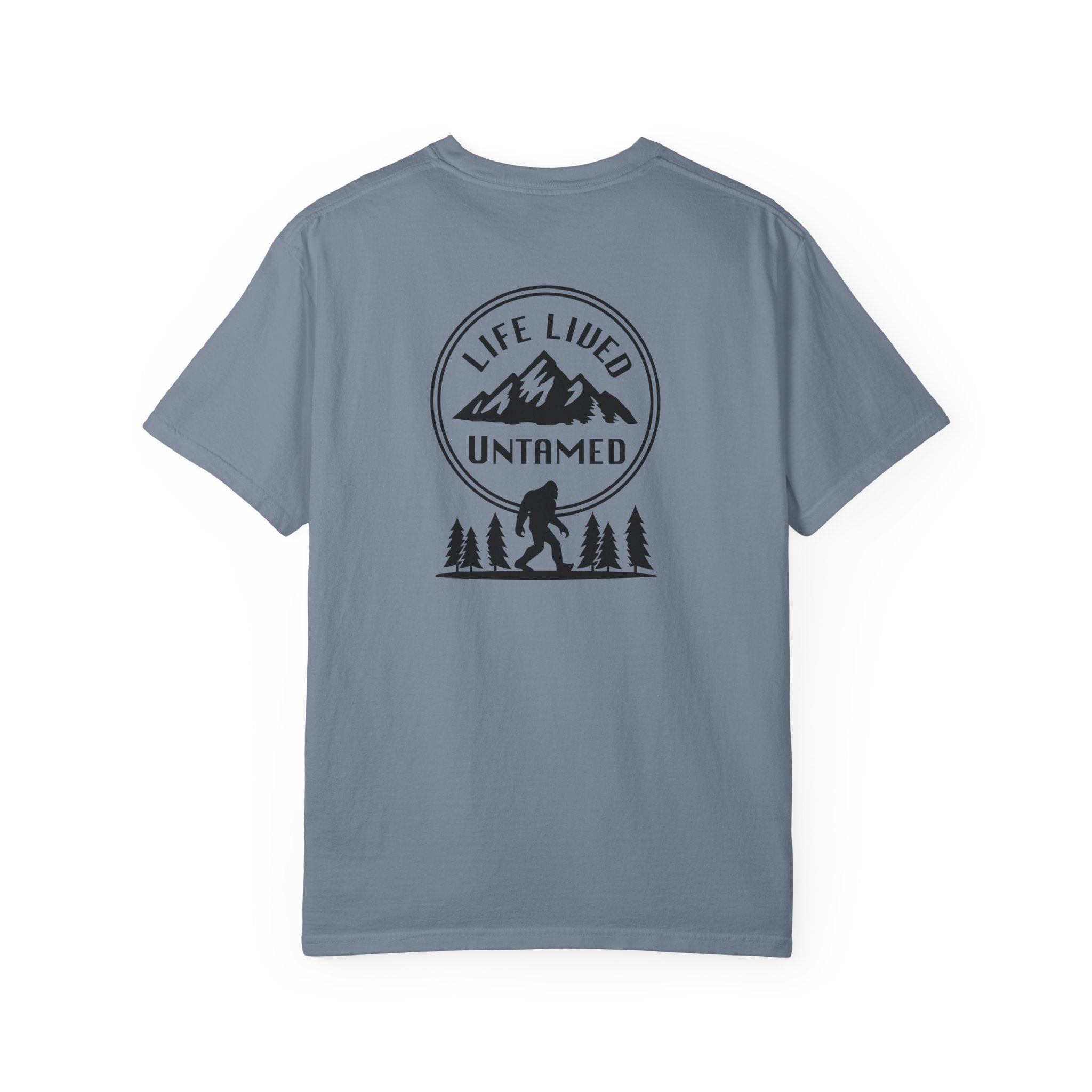 Blue jean t-shirt with a graphic design on the back featuring mountains, trees, and a silhouette of a Sasquatch.