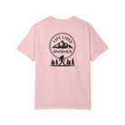 Blossom pink t-shirt with a black graphic design on the back featuring mountains, trees, and a silhouette of a person