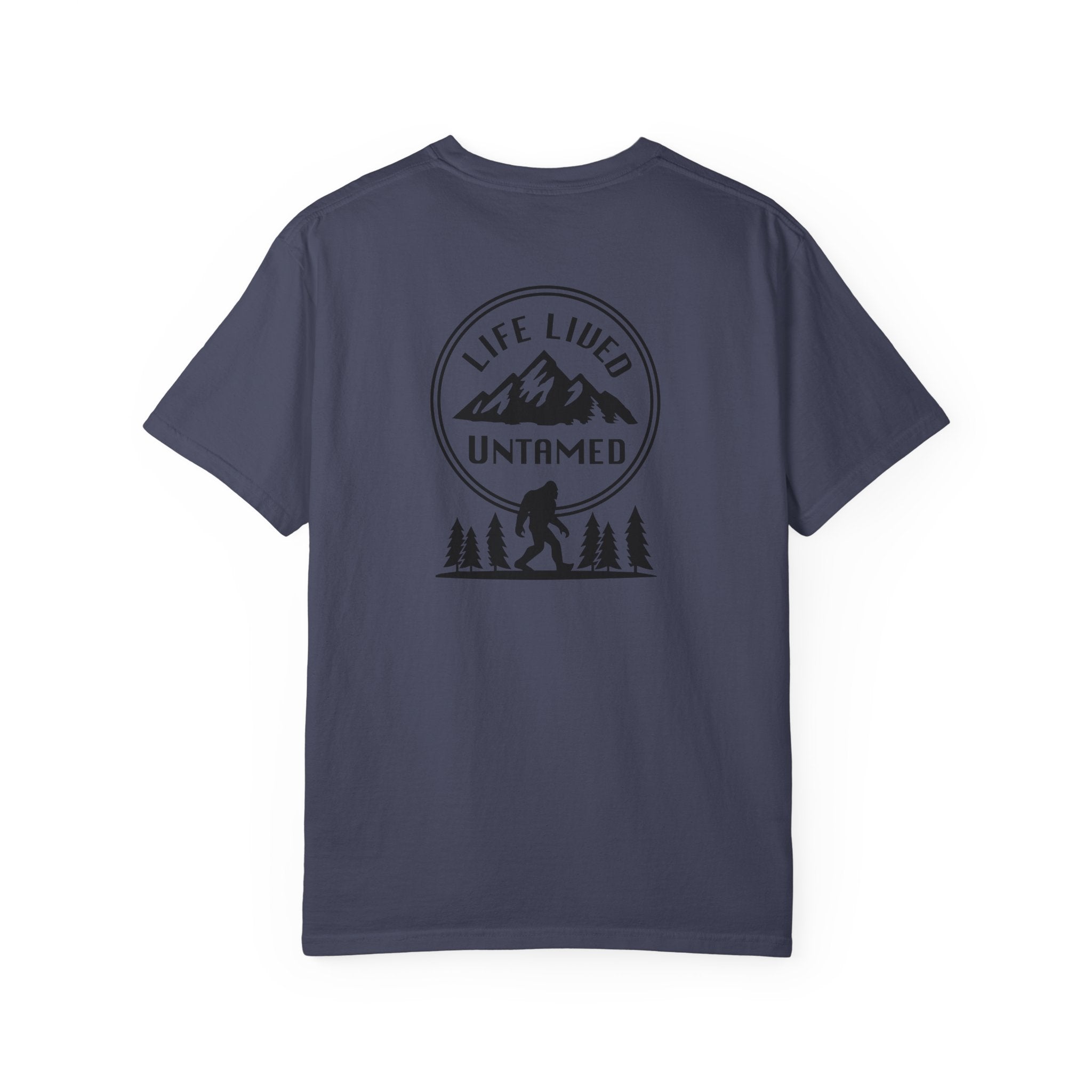 Denim blue t-shirt with a black graphic design on the back featuring mountains, trees, and a silhouette of a Sasquatch
