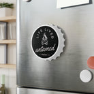 Stainless steel refrigerator with a decorative magnet featuring 'Life Lived Untamed' text.