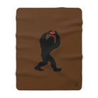 Brown sherpa blanket with a black silhouette of a Sasquatch holding a red heart on a white background