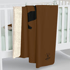 Brown blanket with a logo on a white surface