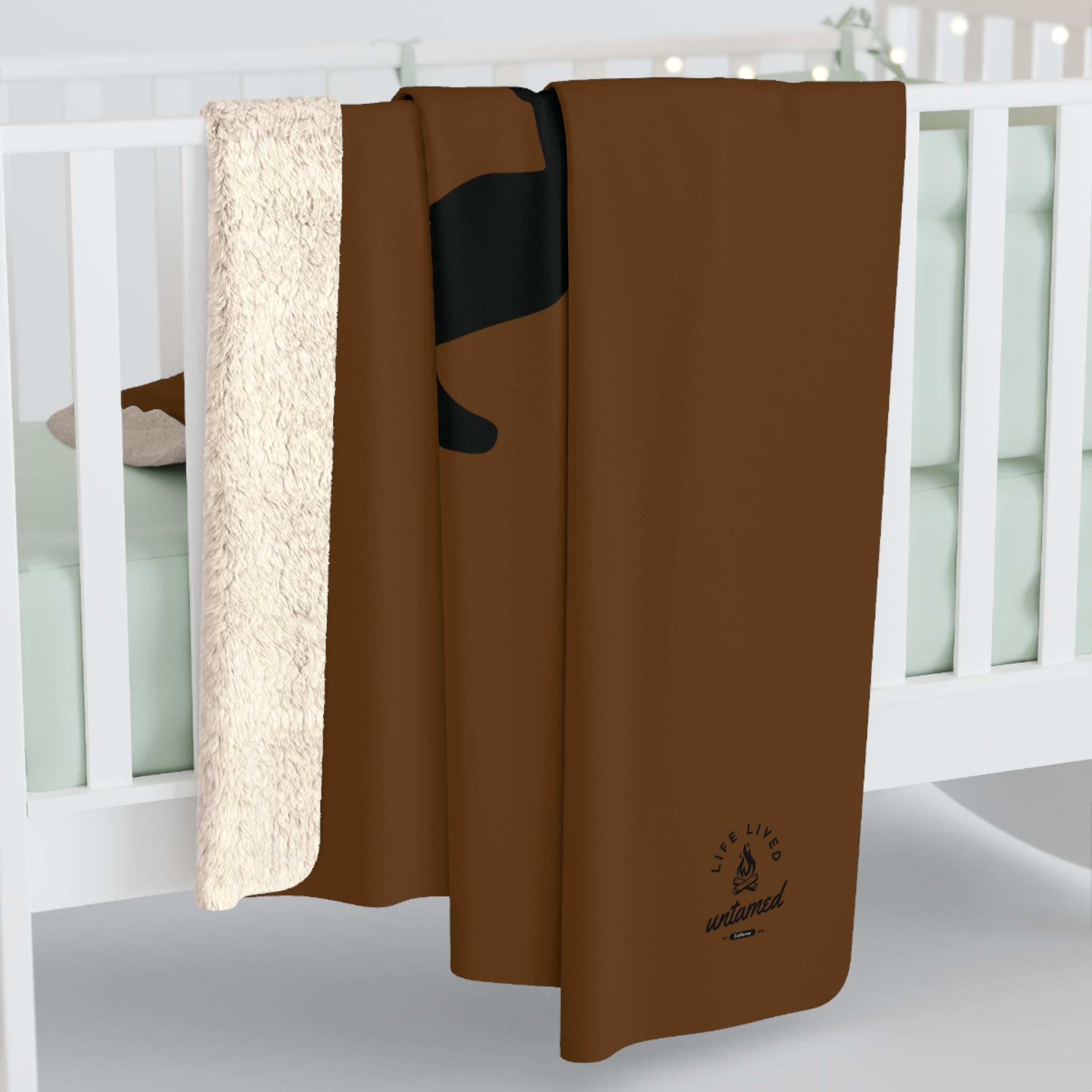 Brown blanket with a logo on a white surface