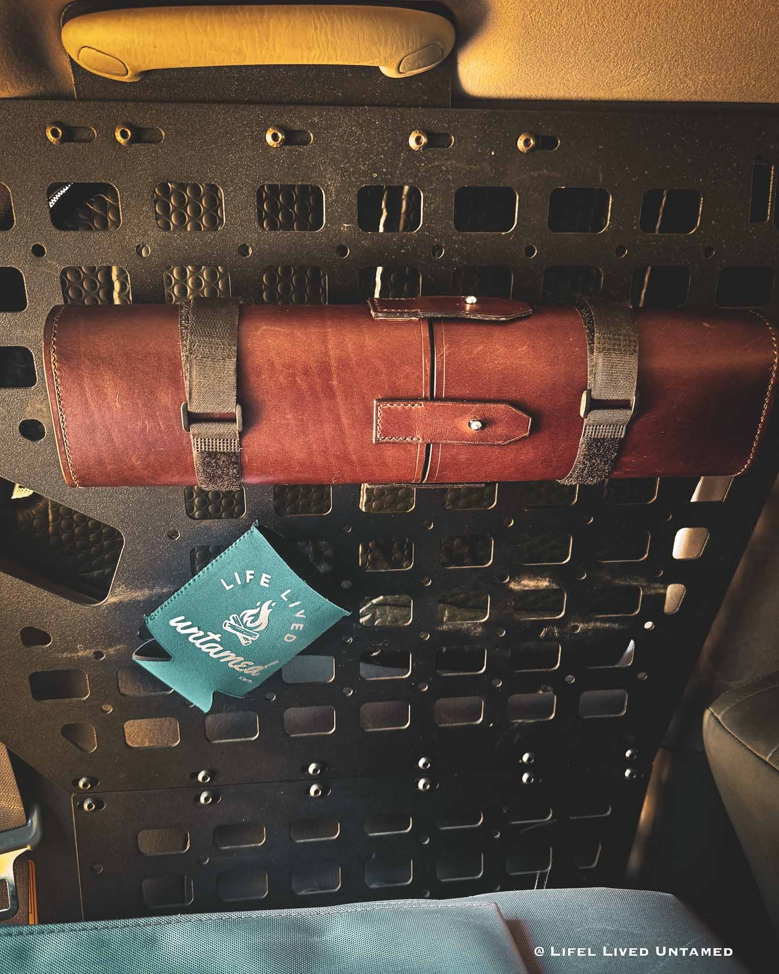 Brown leather tool-roll on a Molle panel