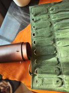 Dark green waxed canvas fabric inserts of the tool-roll with ranches and one side of case