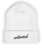 White beanie with 'untamed' text on a white background