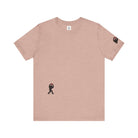 Women's peach t-shirt with small black Sasquatch graphic on lower front and a sleeve on a white background
