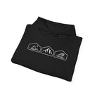 A folded black hoodie with white mountain, desert and wave design on a white background.