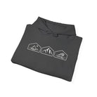 A folded dark gray hoodie with mountain, desert and wave design on a white background.