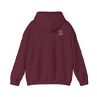 Maroon hoodie with a white ‘Lived Untamed' logo on the back with the hood down against a white background.
