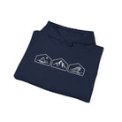 A folded navy blue hoodie with white mountain, desert and wave graphics against a white background.