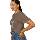 Woman wearing a brown t-shirt with a graphic design on a white background