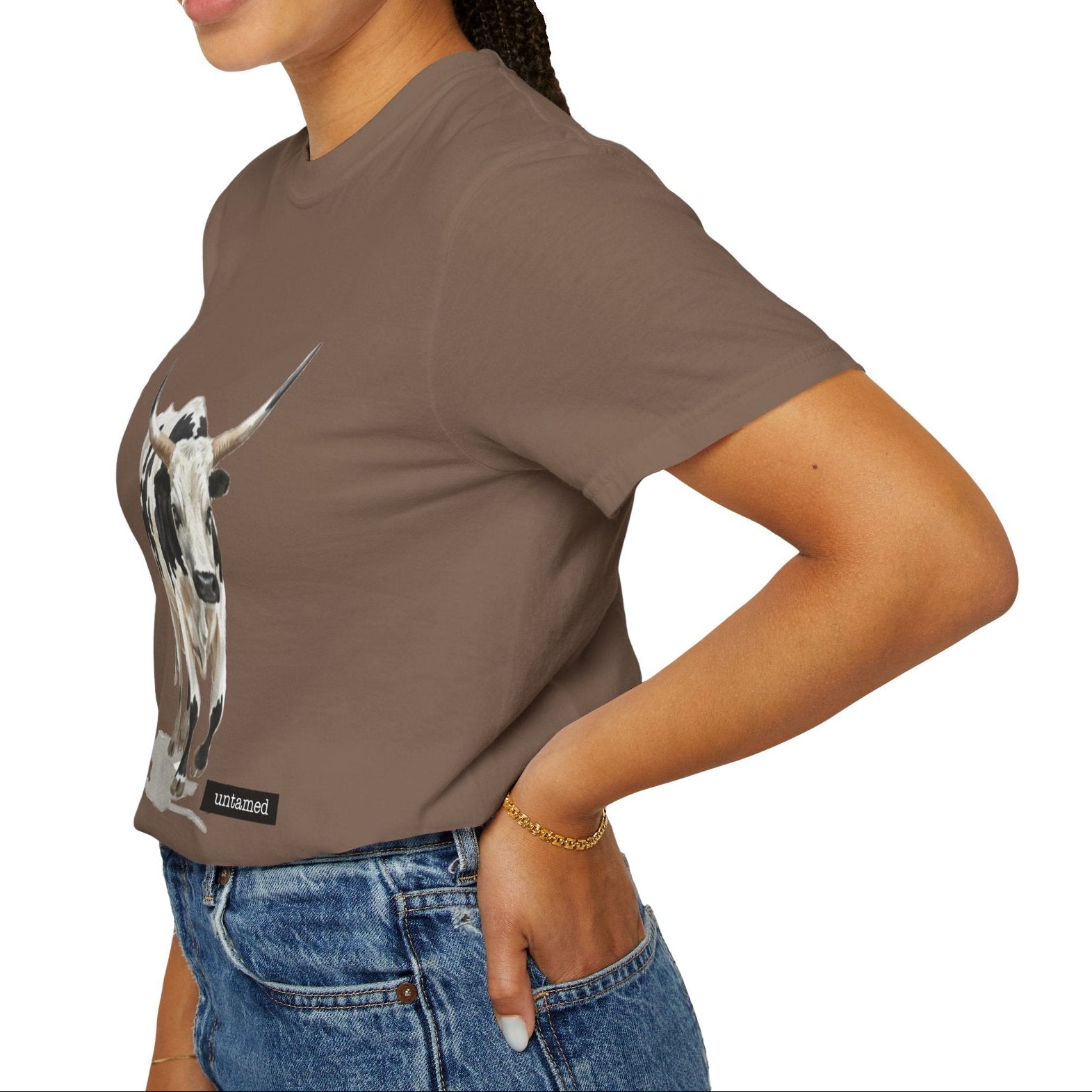 Woman wearing a brown t-shirt with a graphic design on a white background