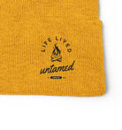 Yellow beanie with 'Life Lived Untamed' logo on a white background