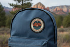 Blue  denim backpack with a Sedona Star patch  in a natural setting