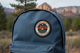Blue  denim backpack with a Sedona Star patch  in a natural setting